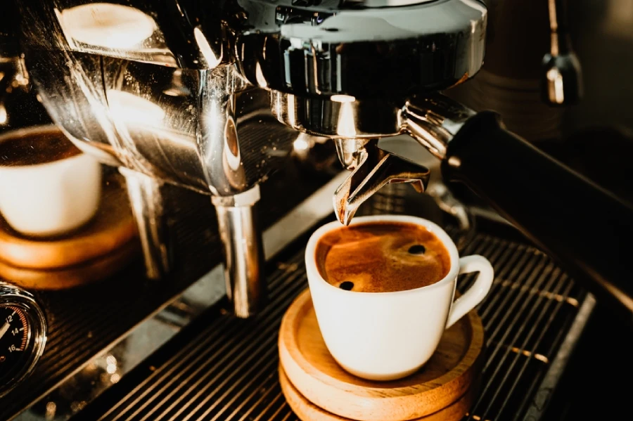 An espresso under an espresso machine.